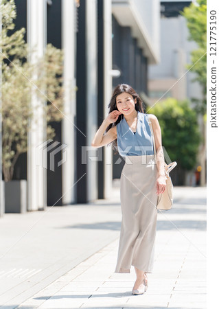 A businesswoman walking through the business district of Hirokoji-dori in Fushimi, Nagoya 121775190