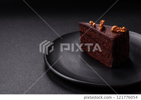 Piece of sweet chocolate cake with nuts Piece of sweet chocolate cake with nuts 121776054