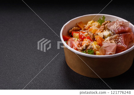 Appetizing salad with prosciutto, pumpkin, cheese and tomatoes 121776248