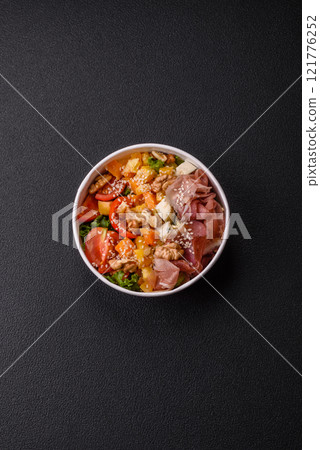 Appetizing salad with prosciutto, pumpkin, cheese and tomatoes 121776252