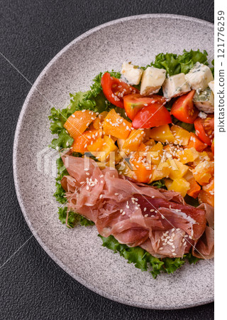 Appetizing salad with prosciutto, pumpkin, cheese and tomatoes Appetizing salad with prosciutto, pumpkin, cheese and tomatoes 121776259