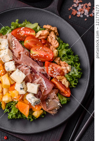 Appetizing salad with prosciutto, pumpkin, cheese and tomatoes Appetizing salad with prosciutto, pumpkin, cheese and tomatoes 121776273