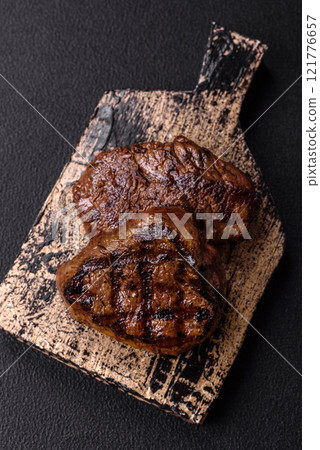 Juicy beef steak baked on the grill with salt, spices and herbs 121776657