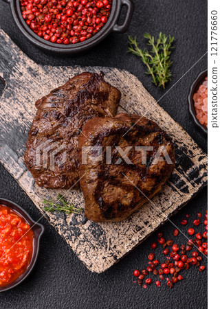 Juicy beef steak baked on the grill with salt, spices and herbs Juicy beef steak baked on the grill with salt, spices and herbs 121776660