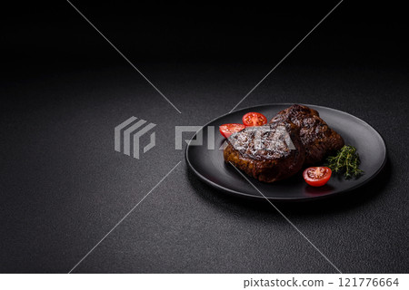 Juicy beef steak baked on the grill with salt, spices and herbs 121776664