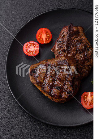 Juicy beef steak baked on the grill with salt, spices and herbs 121776669