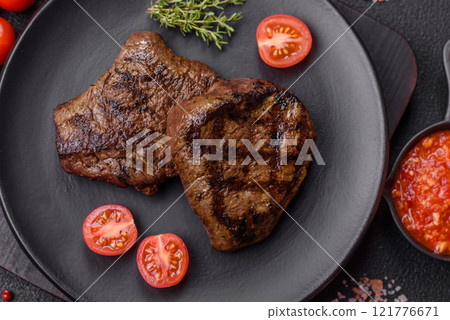 Juicy beef steak baked on the grill with salt, spices and herbs 121776671