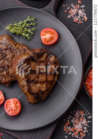 Juicy beef steak baked on the grill with salt, spices and herbs Juicy beef steak baked on the grill with salt, spices and herbs 121776672