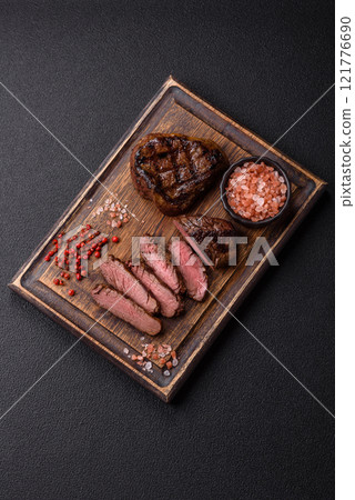 Juicy beef steak baked on the grill with salt, spices and herbs Juicy beef steak baked on the grill with salt, spices and herbs 121776690