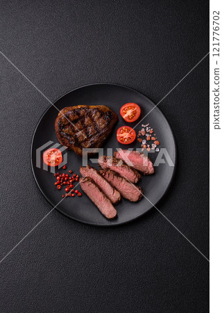 Juicy beef steak baked on the grill with salt, spices and herbs Juicy beef steak baked on the grill with salt, spices and herbs 121776702