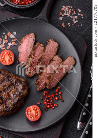 Juicy beef steak baked on the grill with salt, spices and herbs 121776708