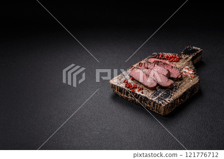 Juicy beef steak baked on the grill with salt, spices and herbs 121776712