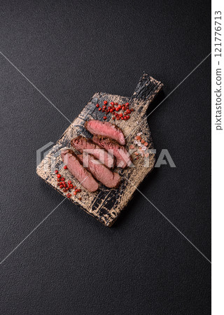 Juicy beef steak baked on the grill with salt, spices and herbs 121776713