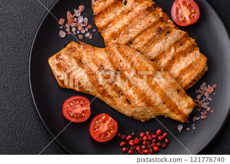 Juicy chicken fillet baked on the grill with salt, spices and herbs Juicy chicken fillet baked on the grill with salt, spices and herbs 121776740