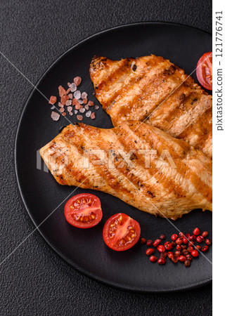 Juicy chicken fillet baked on the grill with salt, spices and herbs 121776741