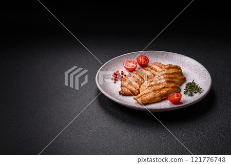 Juicy chicken fillet baked on the grill with salt, spices and herbs Juicy chicken fillet baked on the grill with salt, spices and herbs 121776748