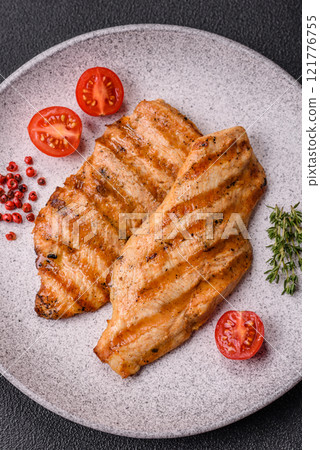 Juicy chicken fillet baked on the grill with salt, spices and herbs Juicy chicken fillet baked on the grill with salt, spices and herbs 121776755