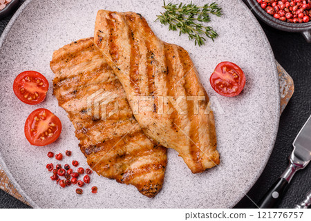 Juicy chicken fillet baked on the grill with salt, spices and herbs Juicy chicken fillet baked on the grill with salt, spices and herbs 121776757