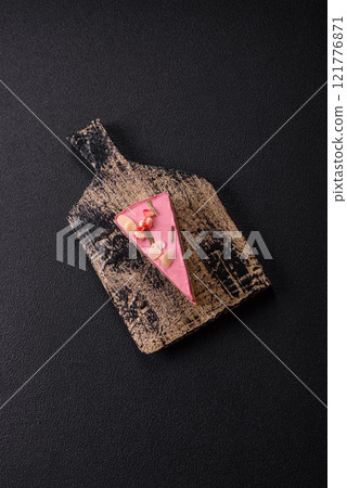 Piece of sweet cheesecake with pink cream cheese of raspberry or strawberry flavor Piece of sweet cheesecake with pink cream cheese of raspberry or strawberry flavor 121776871