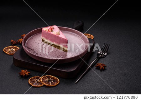 Piece of sweet cheesecake with pink cream cheese of raspberry or strawberry flavor 121776890