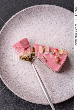 Piece of sweet cheesecake with pink cream cheese of raspberry or strawberry flavor Piece of sweet cheesecake with pink cream cheese of raspberry or strawberry flavor 121776898