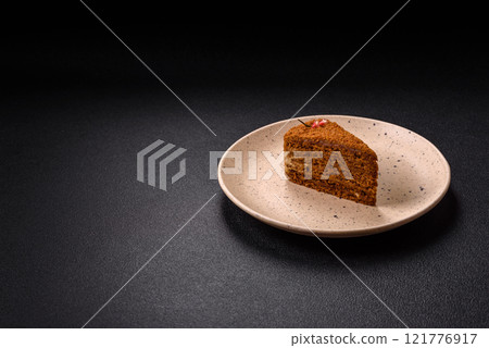 Piece of sweet layered honey cake 121776917