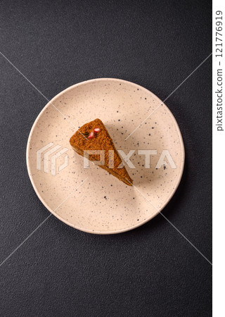Piece of sweet layered honey cake 121776919
