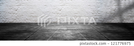 White wall with plastered concrete floor. Abstract pattern of a brick wall 121776975