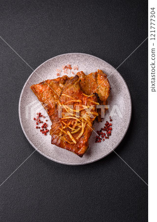 Pork or beef ribs with salt, spices and herbs baked on the grill Pork or beef ribs with salt, spices and herbs baked on the grill 121777304