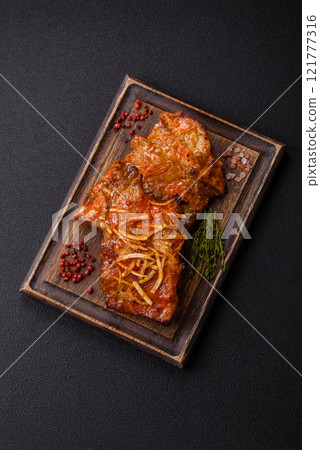 Pork or beef ribs with salt, spices and herbs baked on the grill 121777316