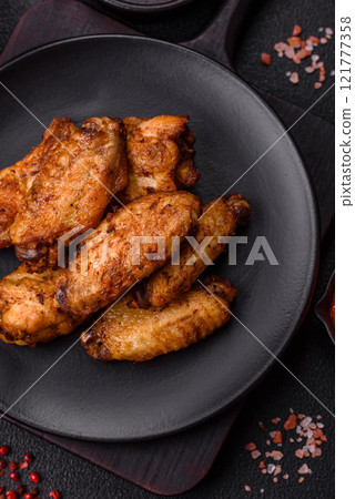 Grilled chicken wings with salt, spices and herbs Grilled chicken wings with salt, spices and herbs 121777358