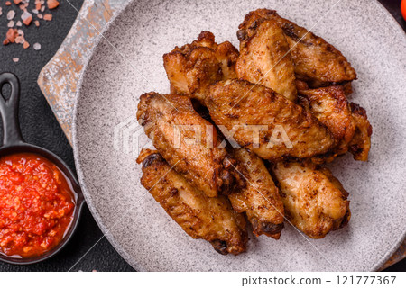 Grilled chicken wings with salt, spices and herbs Grilled chicken wings with salt, spices and herbs 121777367