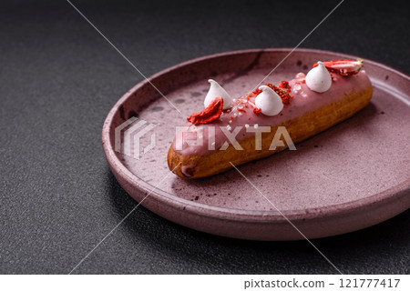 Sweet eclair or profiterole with strawberry custard 121777417