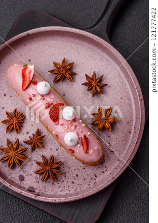 Sweet eclair or profiterole with strawberry custard Sweet eclair or profiterole with strawberry custard 121777422