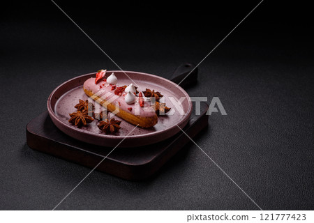 Sweet eclair or profiterole with strawberry custard Sweet eclair or profiterole with strawberry custard 121777423