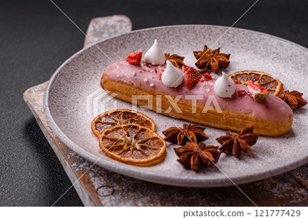 Sweet eclair or profiterole with strawberry custard 121777429