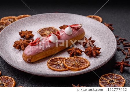 Sweet eclair or profiterole with strawberry custard 121777432