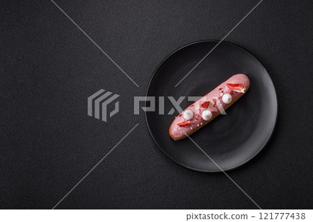 Sweet eclair or profiterole with strawberry custard Sweet eclair or profiterole with strawberry custard 121777438