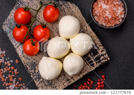 Delicious fresh mozzarella cheese with tomatoes, salt and spices Delicious fresh mozzarella cheese with tomatoes, salt and spices 121777678