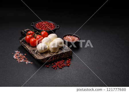 Delicious fresh mozzarella cheese with tomatoes, salt and spices Delicious fresh mozzarella cheese with tomatoes, salt and spices 121777680