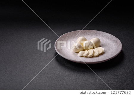 Delicious fresh mozzarella cheese with tomatoes, salt and spices Delicious fresh mozzarella cheese with tomatoes, salt and spices 121777683