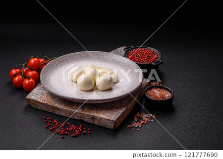 Delicious fresh mozzarella cheese with tomatoes, salt and spices Delicious fresh mozzarella cheese with tomatoes, salt and spices 121777690