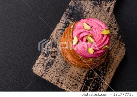 Sweet craffin or panettone garnished with raspberry and pistachio flavored cream Sweet craffin or panettone garnished with raspberry and pistachio flavored cream 121777733