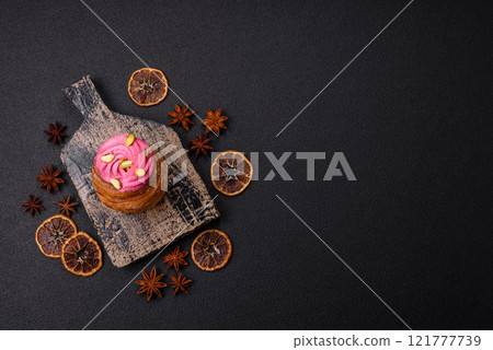 Sweet craffin or panettone garnished with raspberry and pistachio flavored cream 121777739