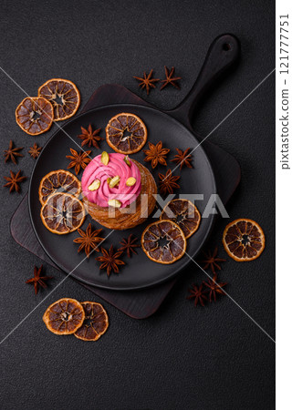 Sweet craffin or panettone garnished with raspberry and pistachio flavored cream Sweet craffin or panettone garnished with raspberry and pistachio flavored cream 121777751
