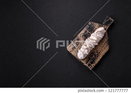 Sweet eclair with custard decorated with coconut slices 121777777