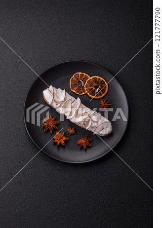 Sweet eclair with custard decorated with coconut slices 121777790