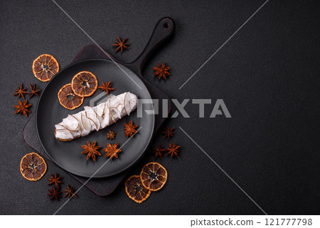 Sweet eclair with custard decorated with coconut slices 121777798