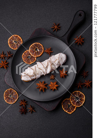 Sweet eclair with custard decorated with coconut slices 121777799