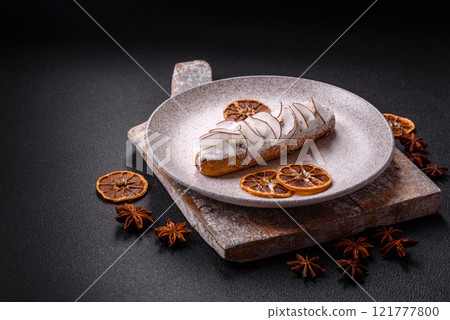 Sweet eclair with custard decorated with coconut slices 121777800